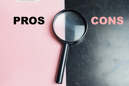 Concept of pros or cons write on color background with magnifying glass.