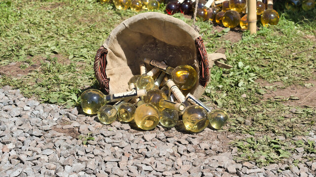 Bocksbeutel wine bottles in a wicker basket at a medieval market.