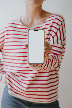 Woman In Red Striped Long Sleeve Top Holding Smartphone With Blank White Screen Towards Camera