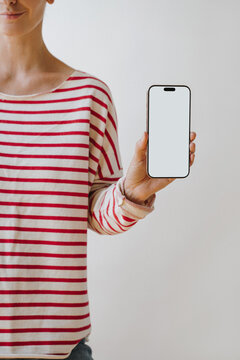 Female Model In Casual Striped Long Sleeve Shirt Displaying Blank Smartphone Screen For App Mockup