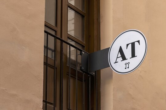 06-10-2024, Teruel, Spain, Tourist Apartment Sign with Two Keys Logo on Beige Building Exterior