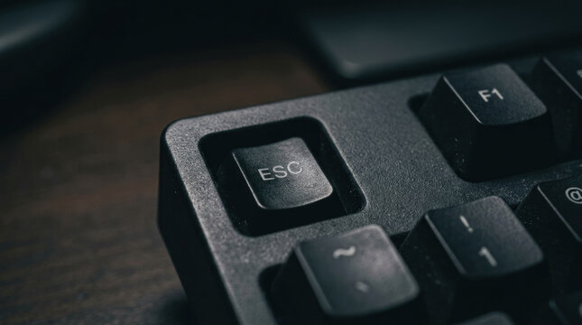 Escape key close up on black keyboard with focus on mental health and workforce productivity