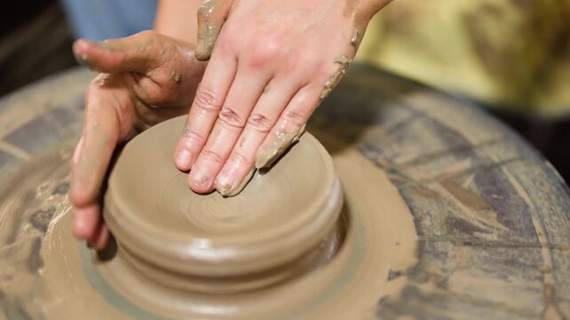 Artisan Hands Shaping Wet Clay on Pottery Wheel in Thailand