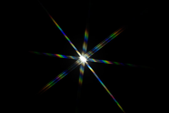 a bright starburst effect with colorful lens flares, often created by photographing a strong light source directly