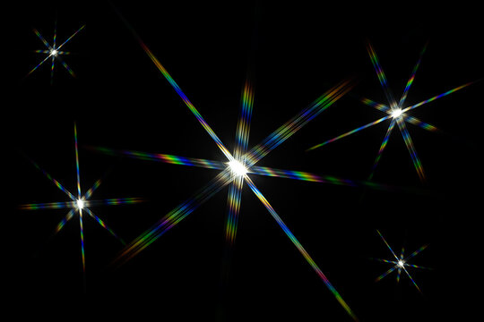a bright starburst effect with colorful lens flares, often created by photographing a strong light source directly