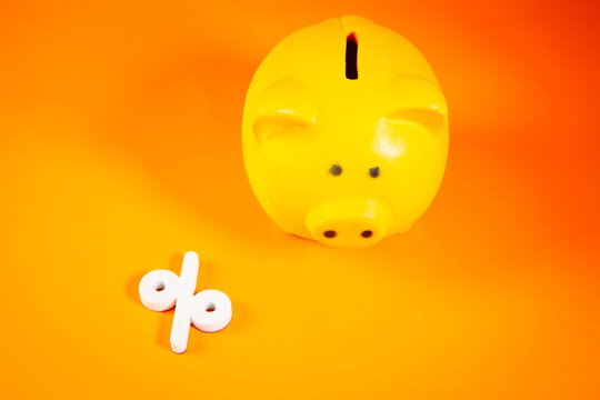 Piggy bank and percentage sign on Saving money concept