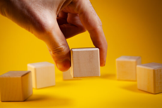 Wooden blocks on a yellow background. The concept of business growth and success.