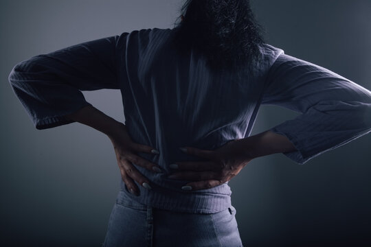 The woman has back pain