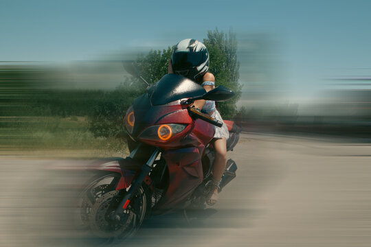 Biker girl in helmet sitting on a motorcycle. Biker concept.