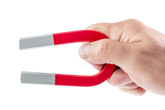 Horseshoe magnet holding in hand isolated on white