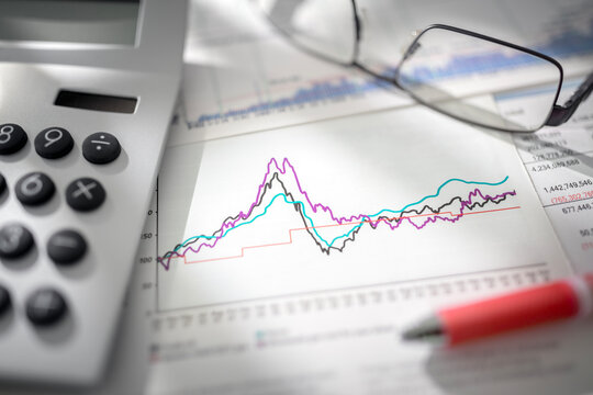 Stock market report graph and financial balance sheet with calculator