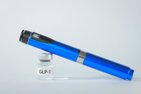 Hopeful medical weight management therapy featuring blue injection pen resting on clinical vial representing obesity treatment