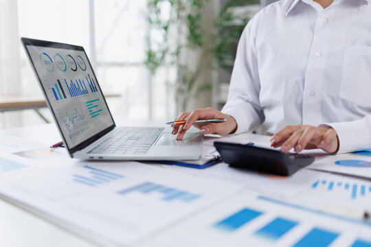 Business woman analysis summary graph reports of business operating expenses and work data about the company's financial statements.