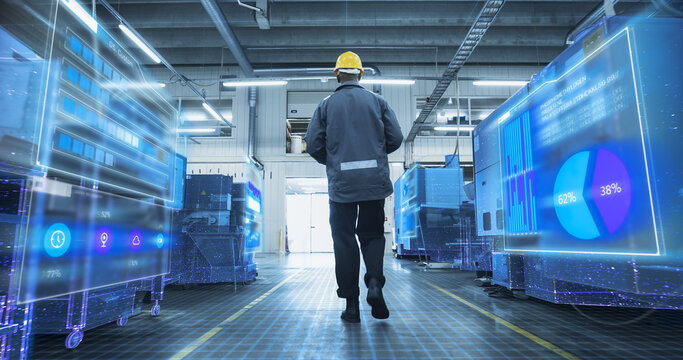 Factory Technician Walks in Manufacturing Facility with AI Data Overlays Scan Equipment, Digital Diagnostics. Visualization of Smart Machines, Monitoring Dashboards, Optimization of Production