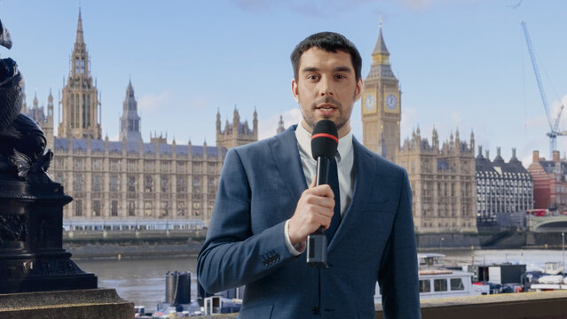 News Anchor Speaks Into a Handheld Microphone While Presenting a Live Television Report on Location by the River Thames, With the Houses of Parliament and Big Ben in the Background