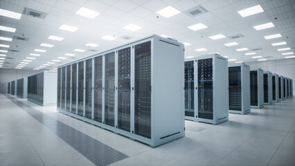 White Modern Data Center Server Room. Wide Angle View Along Parallel Rows of Sealed Cabinets Housing Rack Mounted Compute Nodes as Ceiling Panels Light a Spotless Floor Running Neural Network Training