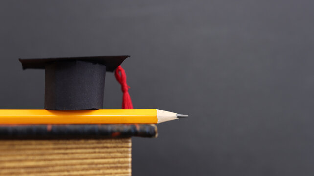 Back to school or education concept. Small graduation hat