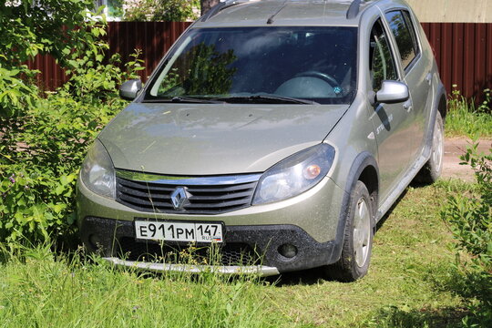 30.06.2026, Russia, Leningrad Oblast, a Renault Sandero car is parked on the grass by the tree