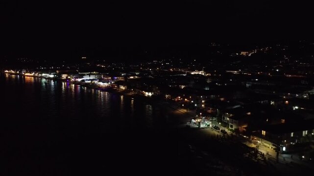 Aerial Night View of Illuminated Coastal Town Beach Resort and Sea Lights 4K
