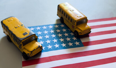 Fototapeta premium toy school bus on the US flag