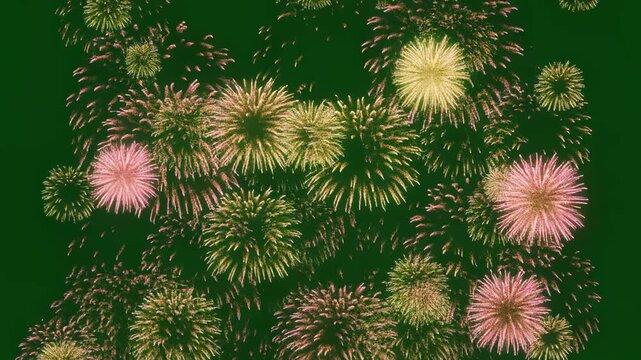Green background fireworks exploding with soft light bokeh and particles in cinematic motion