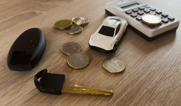 toy car money key calculator lying on the table