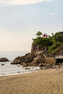 View of Kaizumi Shrine (Ryuo Shrine) perched on Ryuzu Cape at Katsurahama in Kochi, Japan.