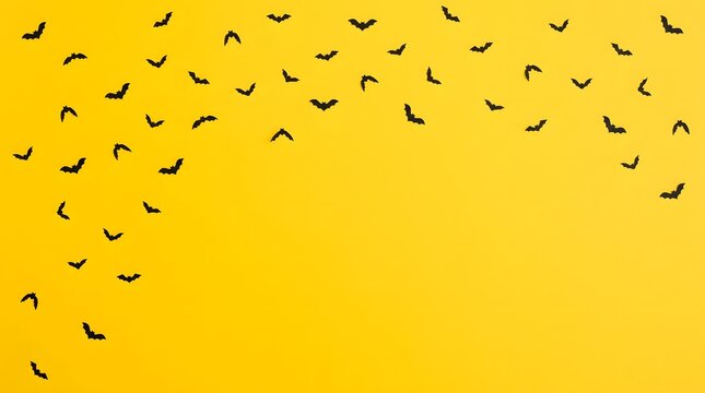 Black bat silhouettes flying diagonally on a vibrant yellow background for halloween party banner.