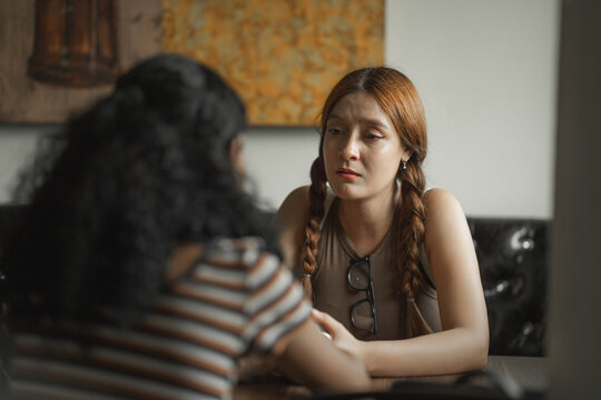Two young women having a serious conversation in a cafe