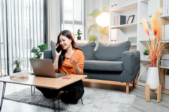 Young asian woman working from home, communicating on smartphone and laptop, managing business remotely, enjoying flexible modern lifestyle and digital connectivity