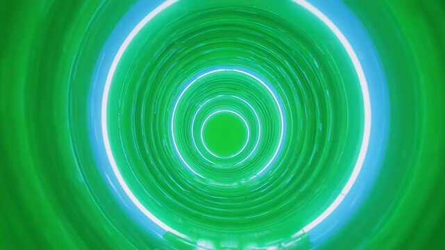Green neon vortex tunnel with glowing concentric circles during a smooth forward camera zoom
