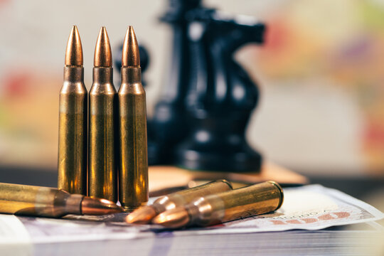 Rifle bullets and chess pieces on world map for geopolitics concept. a conceptual metaphor for global geopolitical conflict military war strategy defense economics and power planning