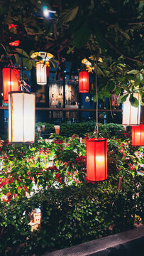 colorful lanterns glowing in thailand night street, tropical evening garden with illuminated lamps