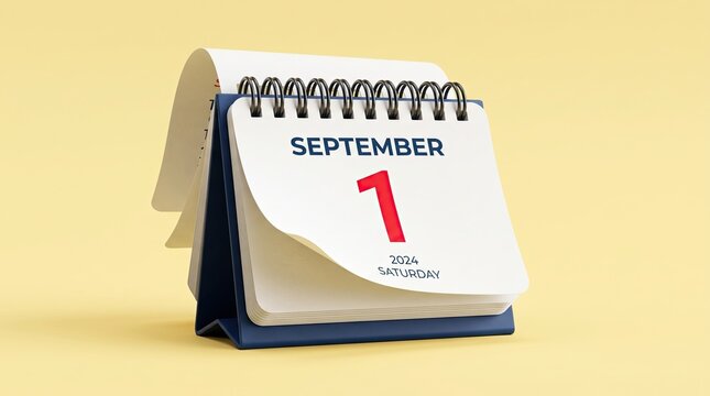 Desktop spiral calendar showing the first of september isolated on a soft yellow background for business planning