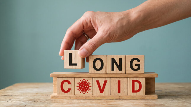Hand arranging wooden blocks spelling "LONG COVID", symbolizing the ongoing health condition, represents persistence and challenge