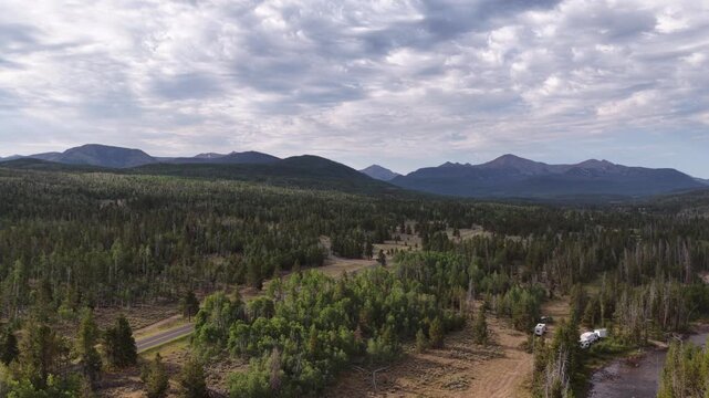 Summer aerial of wilderness camping in Uinta Wasatch Cache National Forest Utah with parked RVs next to creek