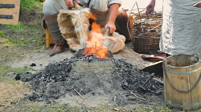 A person is seen preparing a fire using dry materials at an outdoor location. This activity showcases a traditional method of fire creation that highlights survival skills