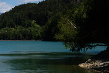 Obraz premium Peaceful Lake With Mountain, Tranquil Alpine Landscape With Shimmering Waters And Slopes
