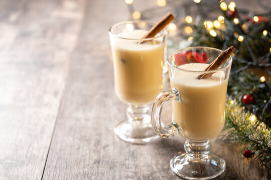 Christmas Eggnog with Cinnamon and Festive Lights. Copy space