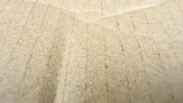 Rough brown cardboard surface texture background close up