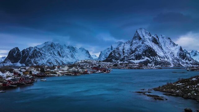 A breathtaking cinematic low-angle timelapse capturing the iconic Reine fishing village, traditional red rorbu cabins, and calm fjord waters under rapidly shifting.