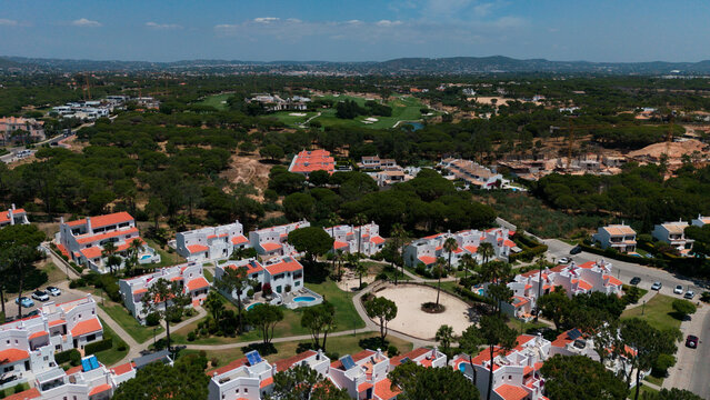 Aerial drone footage, shooting the tourist village of Vale de Lobo, on the shores of the Atlantic Ocean, golf courses for tourists. Portugal, Algarve.