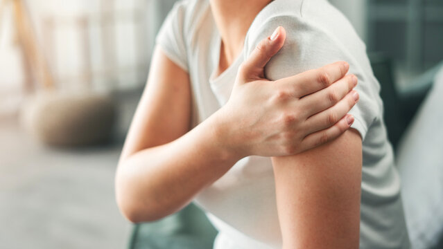 Young woman suffering from arm pain