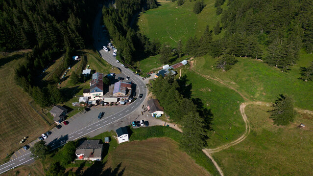Aerial drone landscape of Ergisch alpine village in Switzerland, featuring the iconic church steeple, traditional roofs, and scenic green mountain valley in the Alps, Ergisch, Wasserfall Turtmann