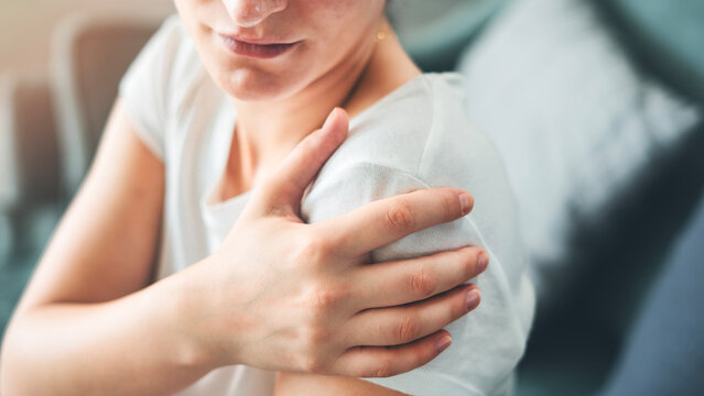 Young woman suffering from arm pain