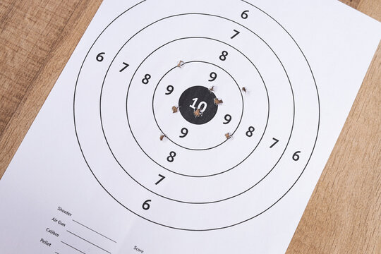 High Angle of Paper Shooting Target with Holes Near Center Bullseye