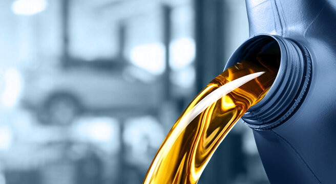 Pouring motor oil into the car engine
