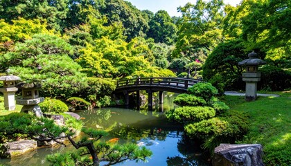 Fototapeta premium Traditional Japanese garden with arched bridge and koi pond.