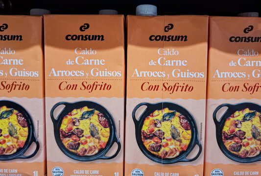 Denia, Spain - October 16, 2025.Cartons of Consum Caldo de Carne Arroces y Guisos con Sofrito on a shelf in a Spanish supermarket