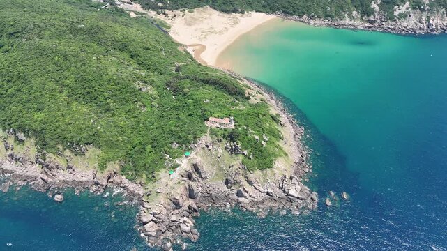 Drone footage captured orbiting Lighthouse and Beach in Dak Lak. From this perspective, the natural arrangement of the coastline and beach forms a silhouette that closely resembles the outline of VN